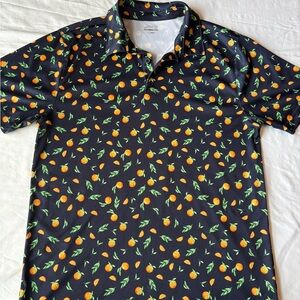 bcg Men’s Golf Orange Polo shirt features a navy background with all over citrus